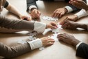 many hands solving a puzzle