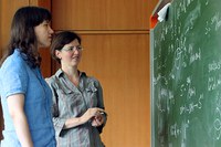 two female researchers in front of blackboard